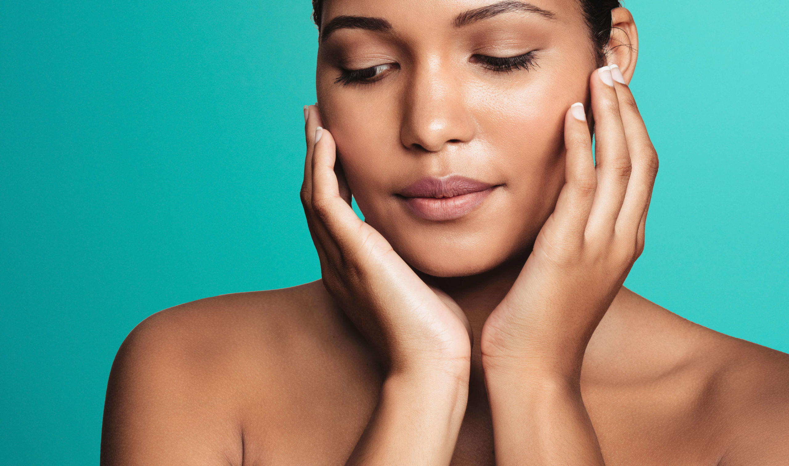 Endolift laser skin lifting London - close-up of a woman with eyes closed framing Close-up of a woman with eyes closed framing her face with both hands against for Endolift laser skin lifting in London