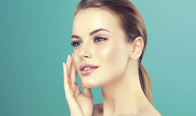 Endolift laser skin lifting London - woman in profile touching her cheek with one hand Woman in profile touching her cheek with one hand against a teal background for Endolift laser skin lifting in London