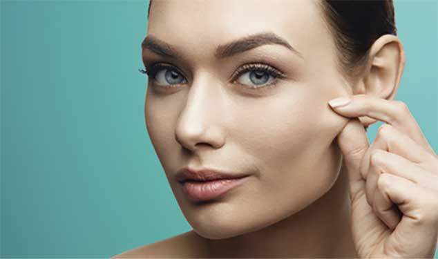 Endolift laser skin lifting London - woman pinching the skin on her cheek Woman pinching the skin on her cheek for Endolift laser skin lifting in London
